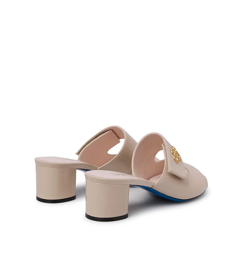 gold metal logo sand leather mules